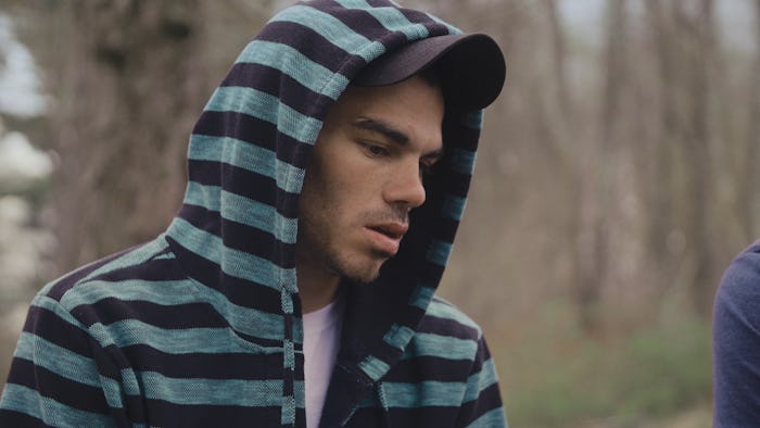 Jeff from Recovery Boys in a black and blue striped hoodie and a black cap