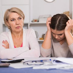 A mom and daughter sitting next to one another. 