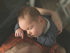 Baby asleep on his mothers chest