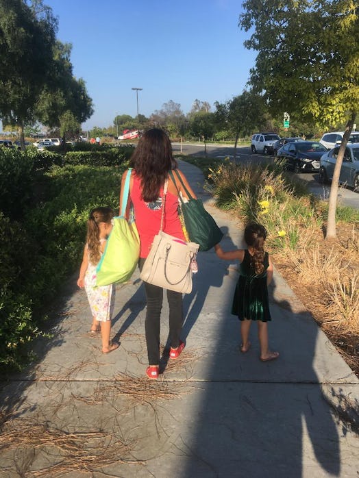 Ambrosia Brody walking on a pedestrian with her two kids