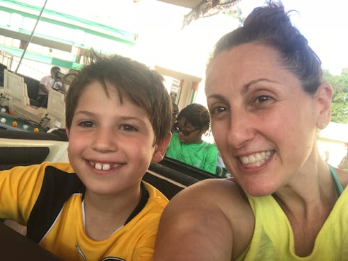 A woman and her son taking a selfie while looking very happy 