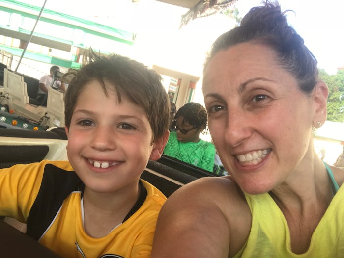 A woman and her son taking a selfie while looking very happy 