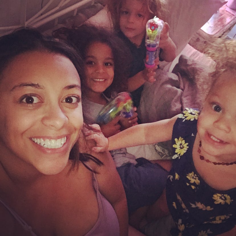 Mother taking a selfie with her three children while they are having a play night