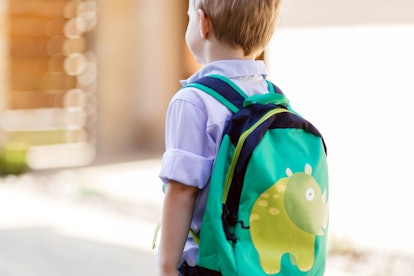 A boy with his backpack on, struggling with back-to-school anxiety