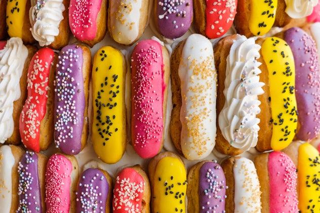 Multicolored eclairs laid out in rows