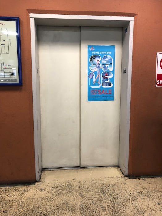 Image of an elevator with a blue poster on it