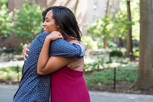 A young lady being hugged