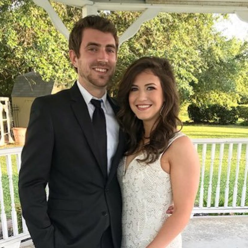 A bride and groom posing for a picture 