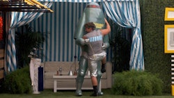 Brett from Big Brother hugging a robot mascot 