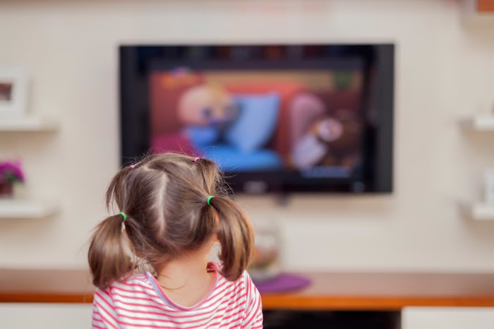 A kid watching TV with a blurred screen