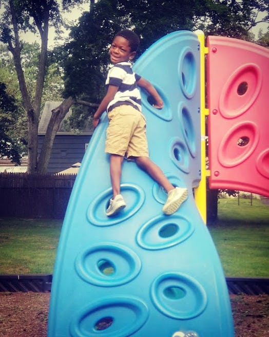 A smiling child on a playground whose mom has back-to-school anxiety that white moms just can't unde...
