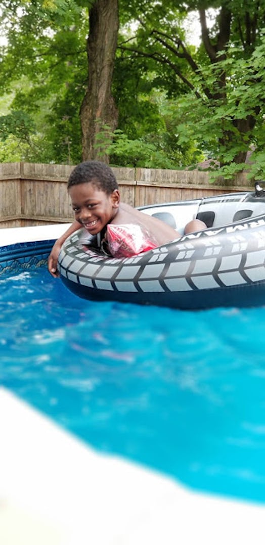 A smiling child in a swimming pool, whose mom has back-to-school anxiety that white moms just can't ...