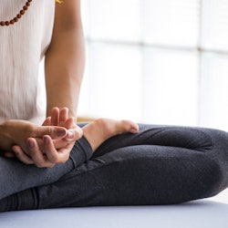 Woman meditating to boost her mood 