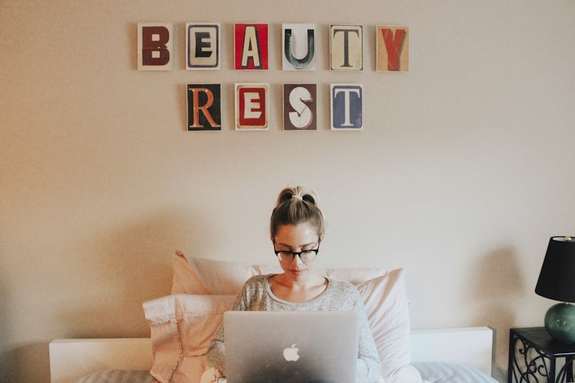 The writer sits in front of a wall hanging saying "Beaty rest." Self-care is an important component ...