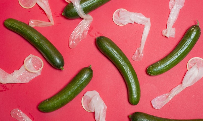 Cucumbers and condoms on a pink floor