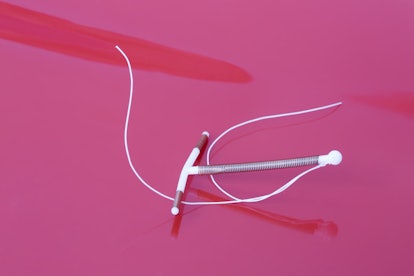 A IUD standing on a purple surface