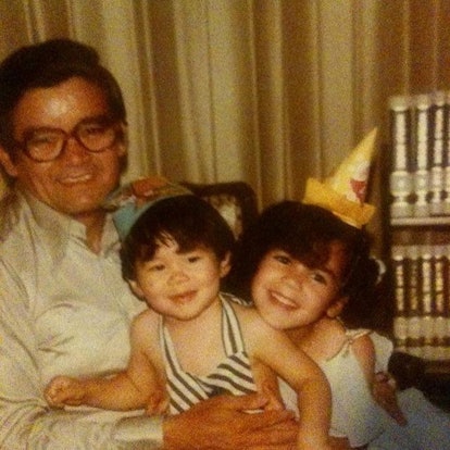 Maria Lau, an Asian-Latinx woman as a child, wearing a birthday cap in a family photo.