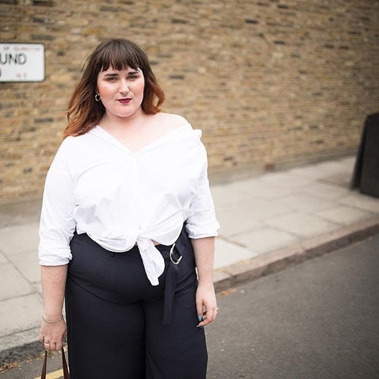 Plus-Size Influencer Bethany Rutter wearing a white shirt while posing for a picture.