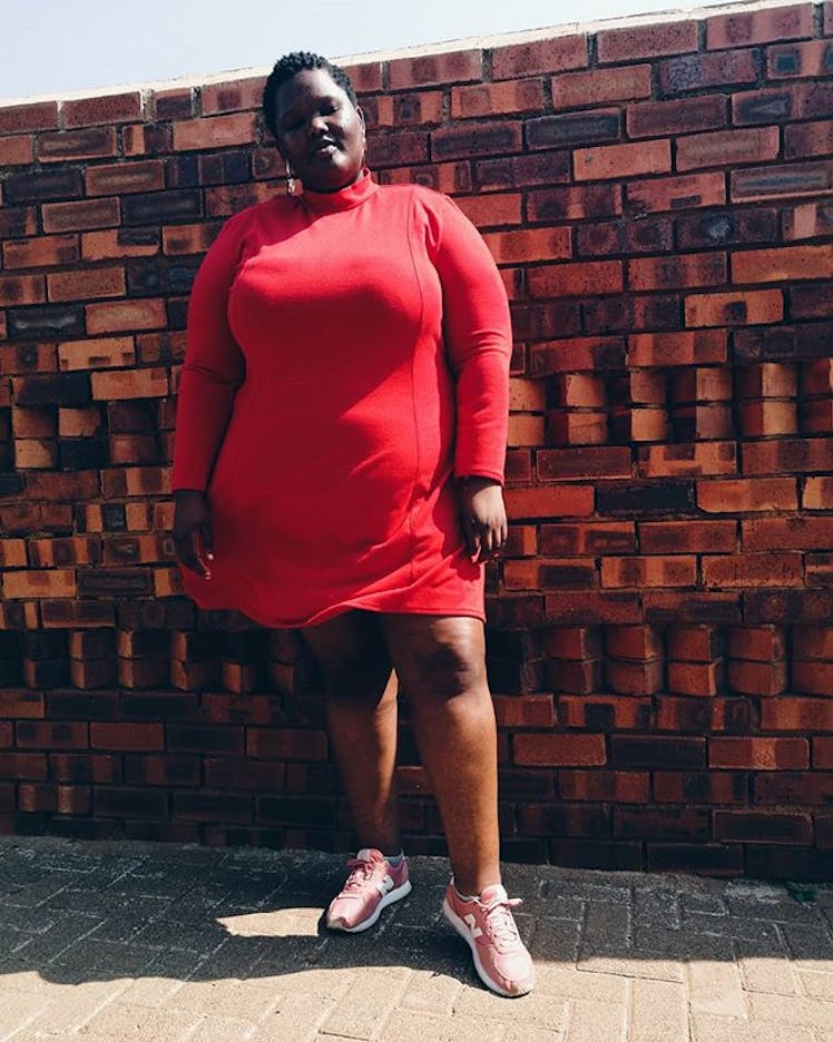 Plus-Size Influencer Nomali wearing a red dress with pair of sneakers. 