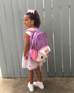 A picture of Kristen's daughter with her unicorn backpack 