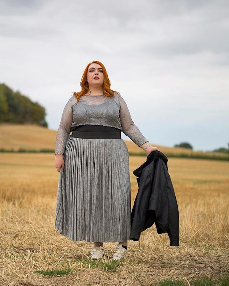 Plus-Size Influencer Nancy Whittington-Coates posing in silver outfit in the middle of the field.