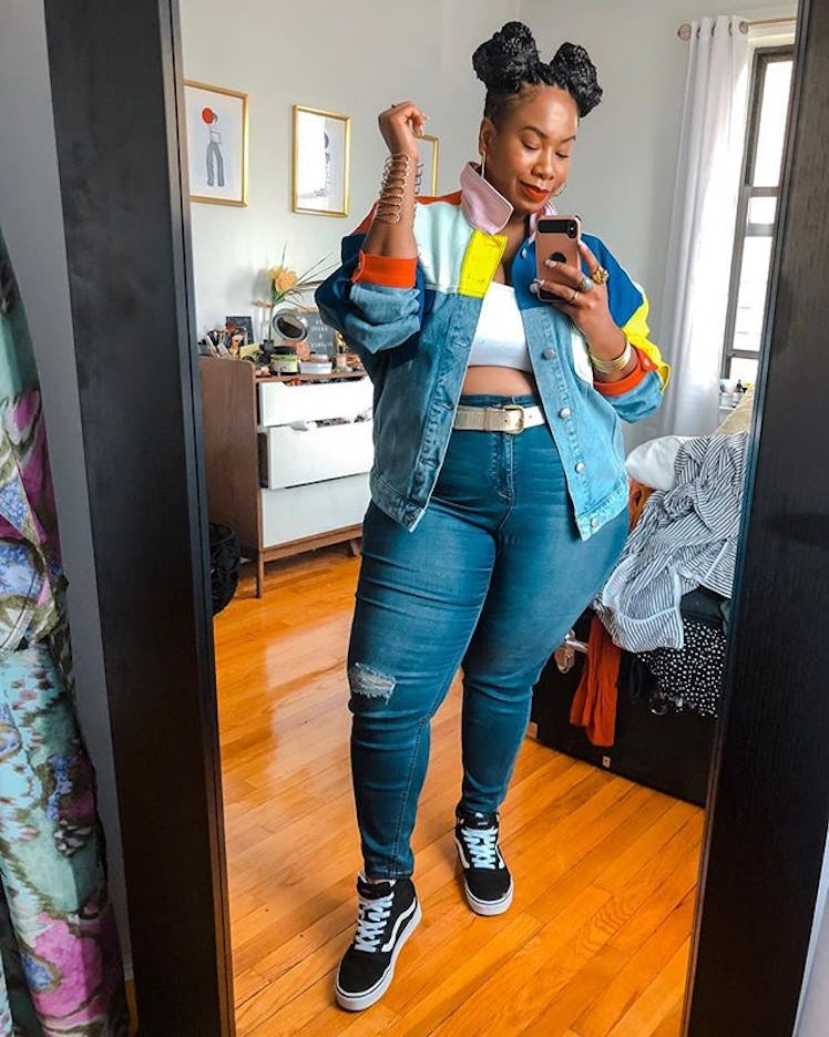 Plus-Size Influencer Kelly Augustine taking a mirror selfie while wearing denim shirt matched with d...