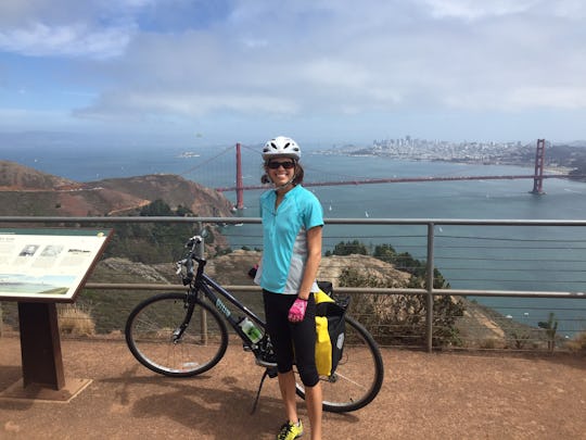 Jackie Noblett, who hoping to get pregnant after going pedal to medal, posing next to her bike