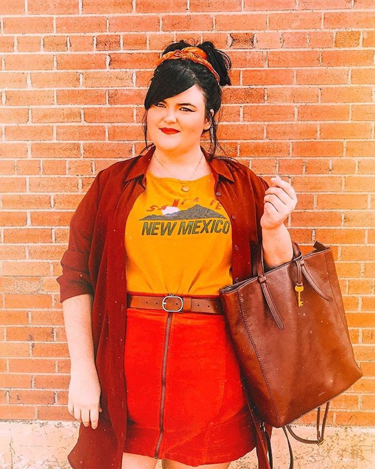 Plus-Size Influencer Rosey Blair wearing orange skirt and red lipstick while posing in front of the ...
