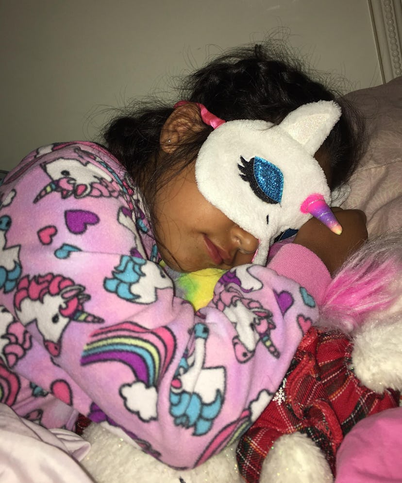 A Kristen's daughter sleeping with her unicorn sleep mask