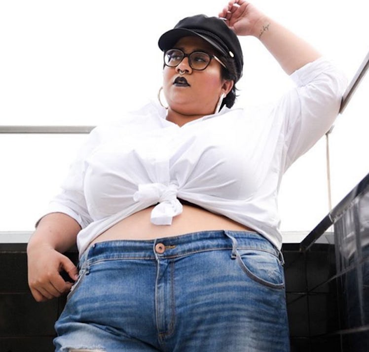Plus-Size Influencer Sapphire Splendour posing for a picture while wearing a white cropped shirt and...