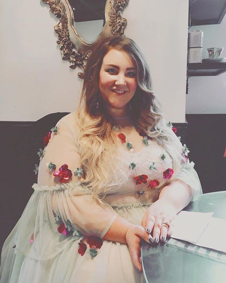 Plus-Size Influencer Courtney Mina wearing a floral dress.