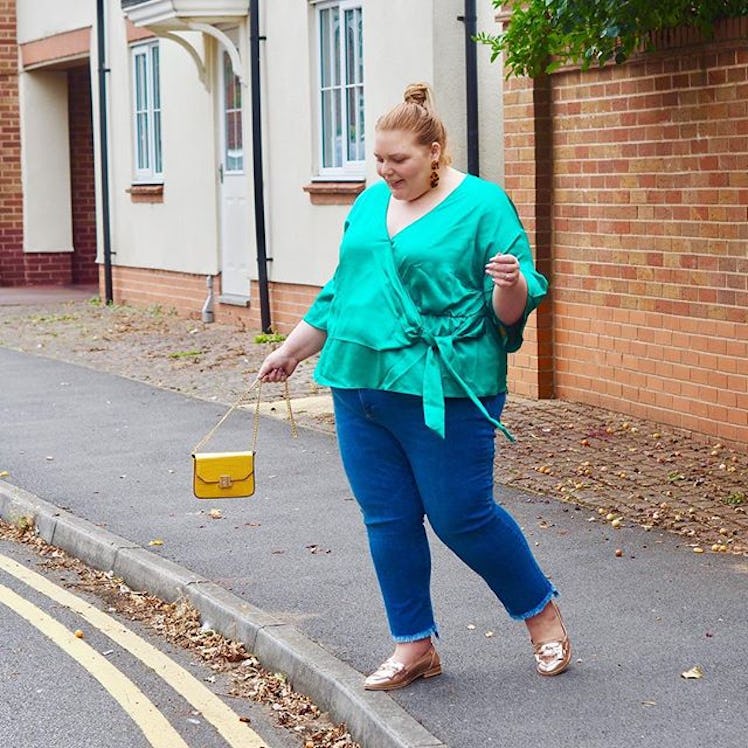 Plus-Size Influencer Hollie Burgess posing in turquoise blouse.