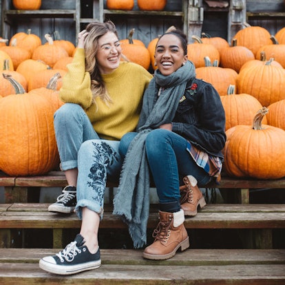 Two girls laughing candidly surrounded by pumpkins is the perfect picture pose to pair with pumpkin ...