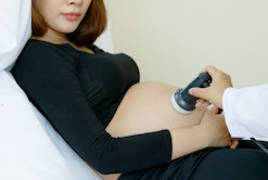 A pregnant woman who has PCOS getting checked by a doctor