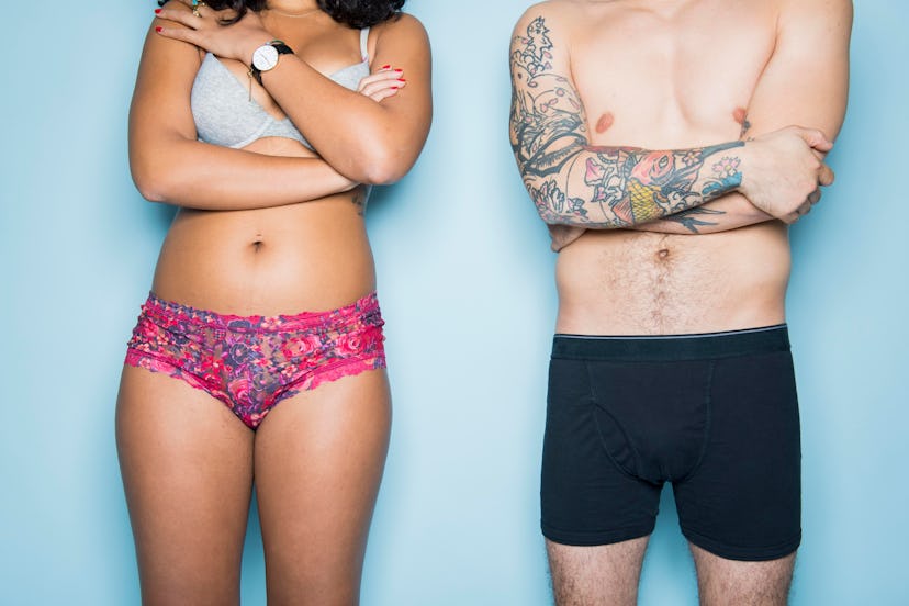 A woman with a bra and underpants standing next to her partner that has only underpants