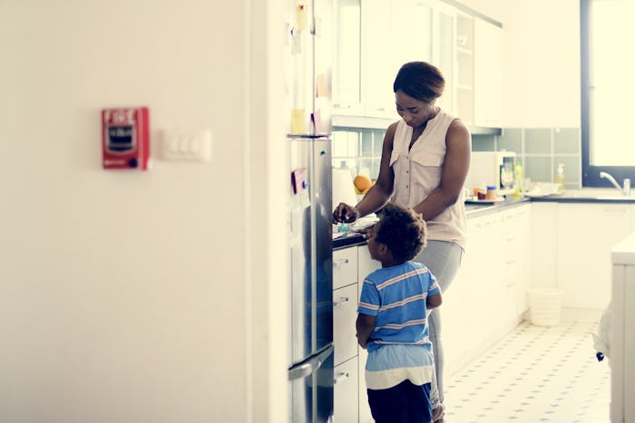 A mom who has anxiety that gets sometimes out of hand, standing in a kitchen with her son
