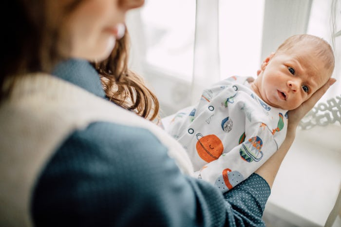 A mother holding her newborn baby in her arms