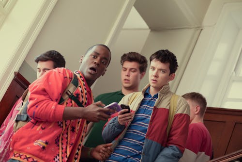 A scene from Sex Education with the characters standing in the hallway with a look of shock.