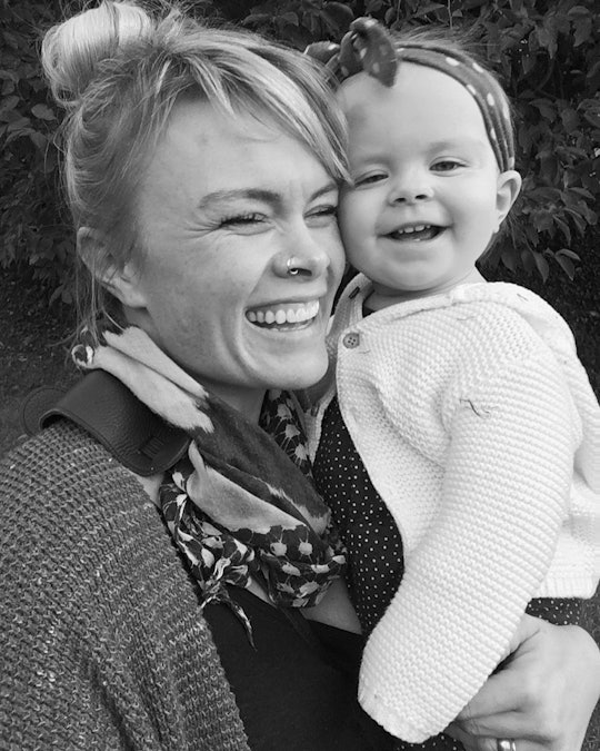 Black and white photo of a woman holding her toddler while they both smile