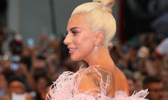 lady gaga displaying her back tattoos, meaningful memorial tattoo ideas