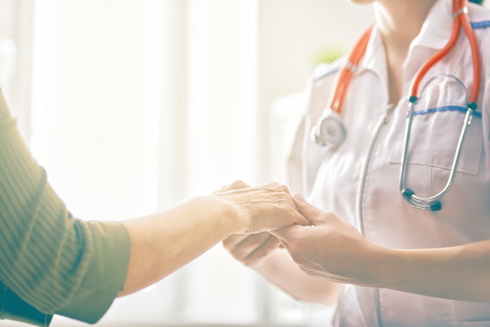 Nurse holding hands with patient