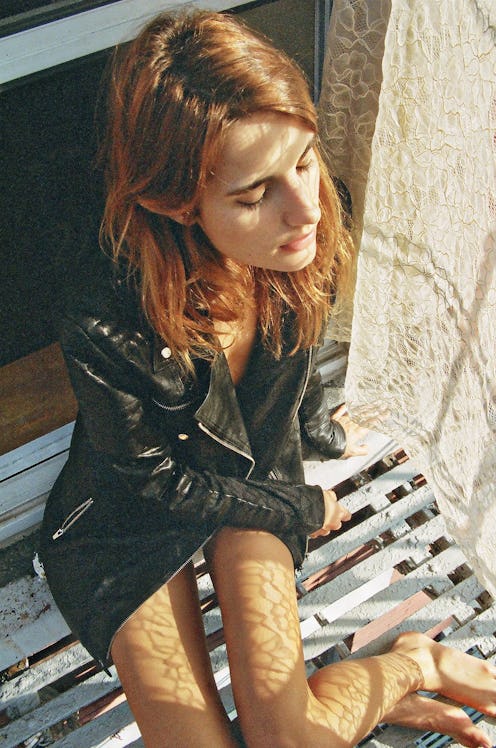 A brunette sun-kissed model sporting the cult Motto Jacket for every It-Girl's closet