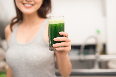 A woman holding a healthy drink for major beauty benefits
