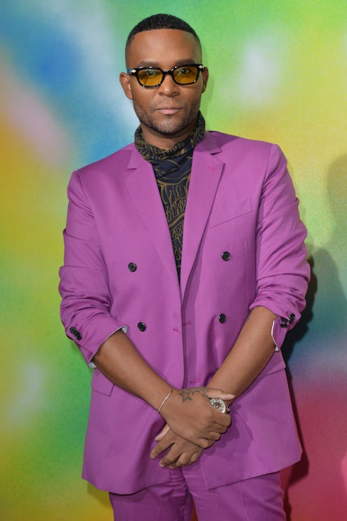 Law Roach in a purple blazer, black shirt and sunglasses