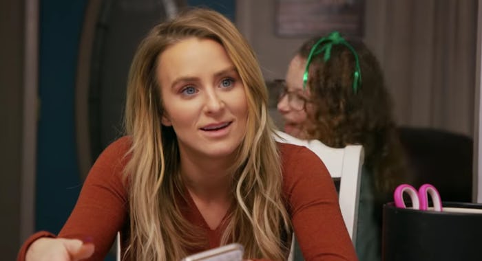 A blonde lady sitting in a red shirt