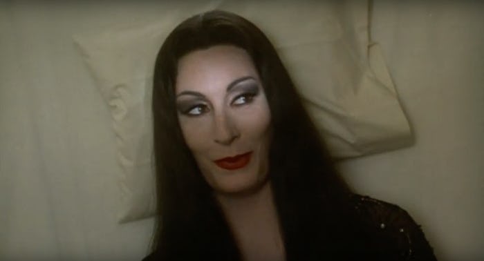 Morticia Addams on a pillow smiling