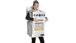 A pregnant woman wearing a costume where she is an oven with a bun in it