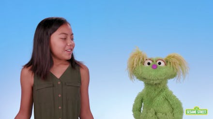 10-year-old Salia Woodbury and Karli the muppet in a 'Sesame Street' video about addiction.