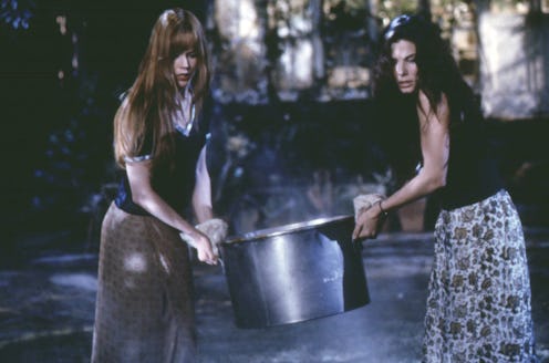 Nicole Kidman and Sandra Bullock carry a cauldron in a scene from the 1998 movie Practical Magic.