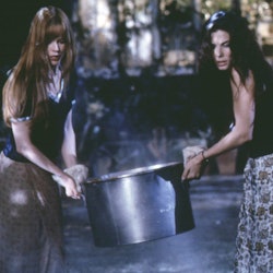 Nicole Kidman and Sandra Bullock carry a cauldron in a scene from the 1998 movie Practical Magic. 